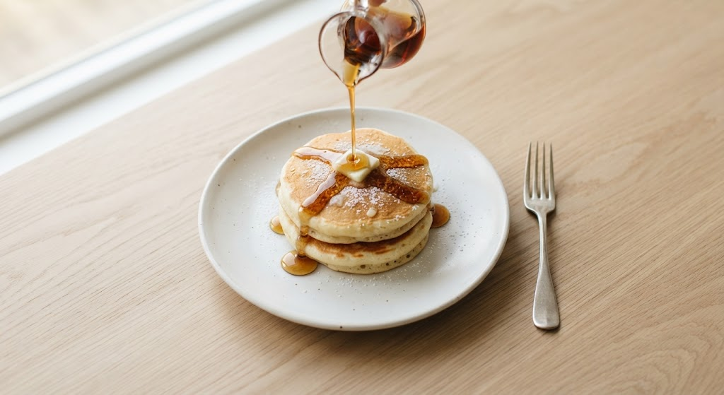 Small stack of pancakes made from a 1 person pancake recipe, topped with maple syrup